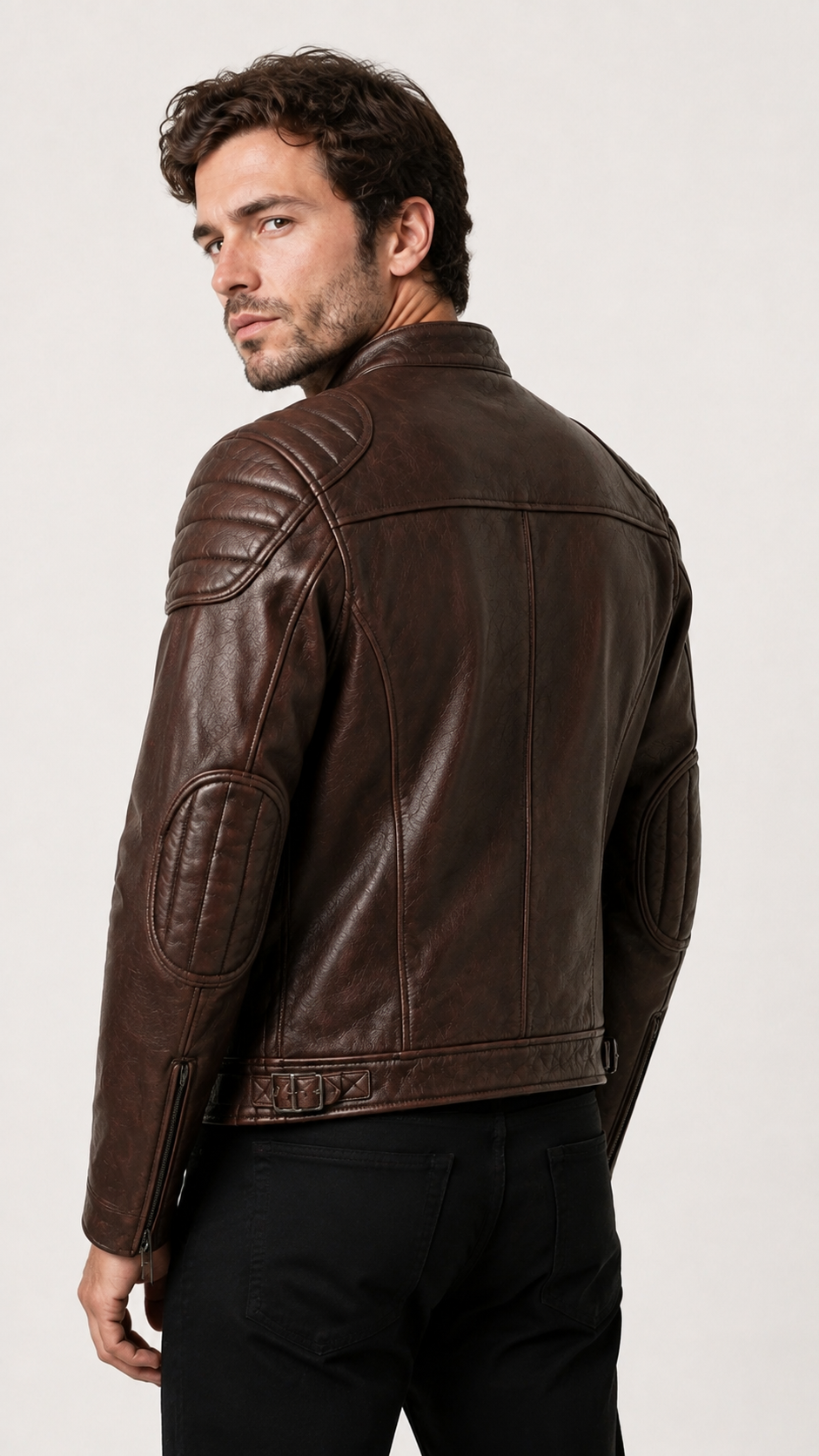 Back view of a man wearing the vintage brown biker jacket with dark jeans — British model